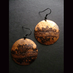 Embossed copper circle with black background earrings